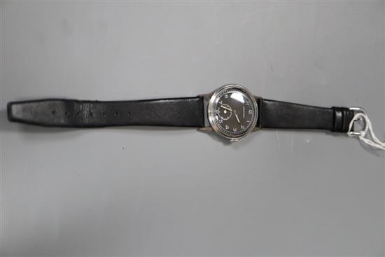 A gentlemans 1950s/1960s? steel Longines black dial manual wind wrist watch, on associated strap.